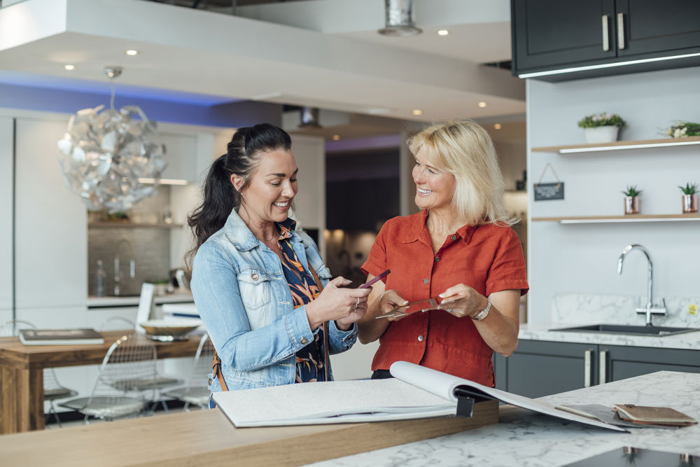 women with plans in showroom
